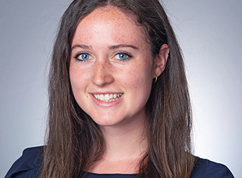 close up of Emma, smiling, wearing a dark blue dress and her James Madison scholar pin