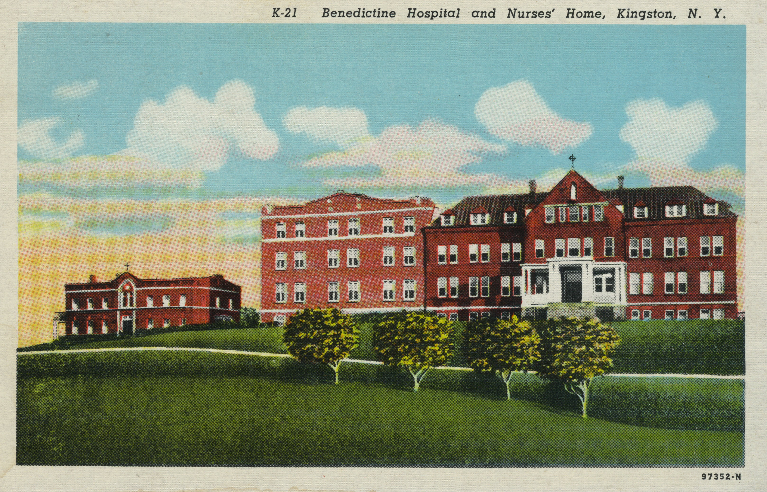 red brick three-story hospital building with a red brick two-story nurses' home to the left side. landscaped lawn and trees in front of both buildings.
