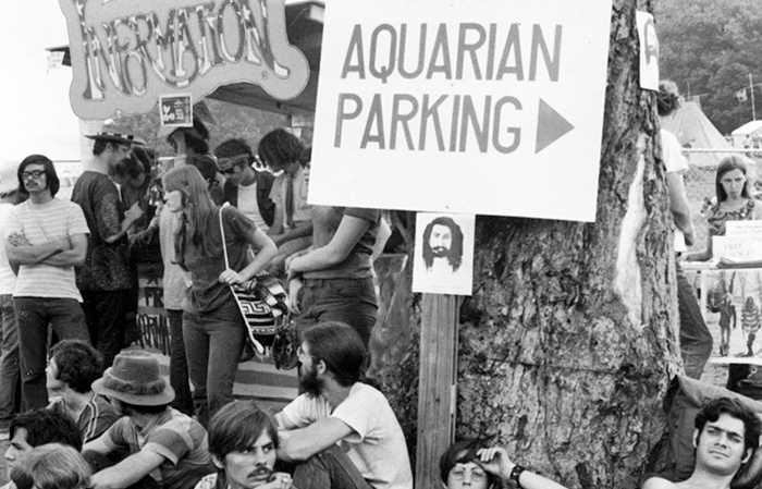 detail of Woodstock Festival photo showing people gathered at an information booth
