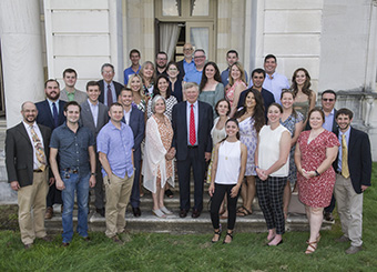 group photo of HRVI staff and alumni gathered on the steps of a mansion