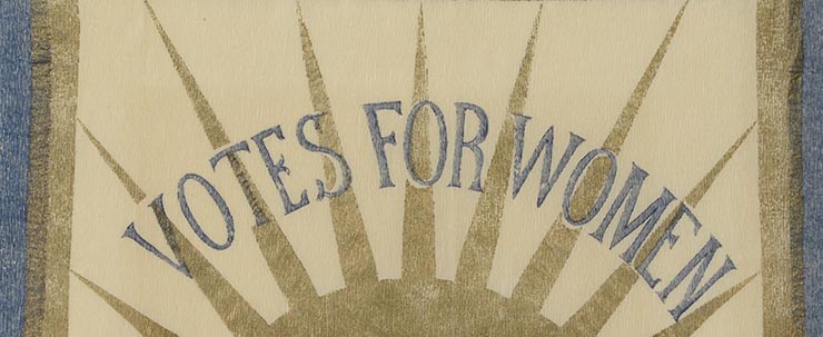 detail of a women's suffrage banner using blue and gold crepe paper