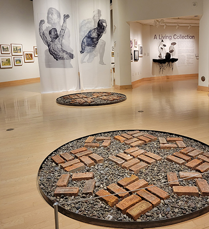 photo of art gallery showing sculpture and paintings
