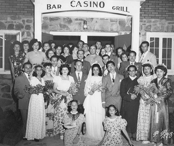 black and white photo of a wedding party gathered on the steps of Casa Perez in Plattekill.
